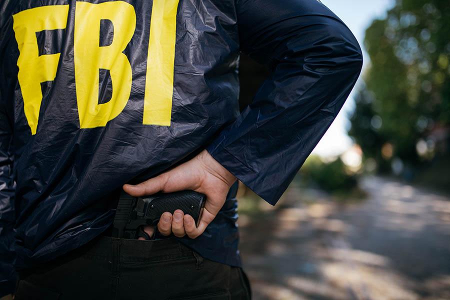 FBI agent pulling out a .40 S&W handgun?