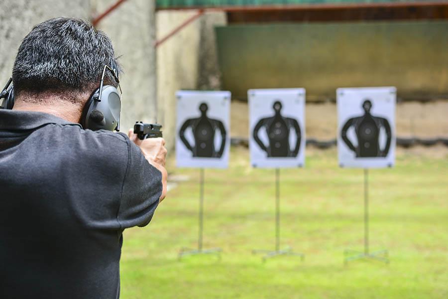 man using a 9mm pistol for target shooting ?
