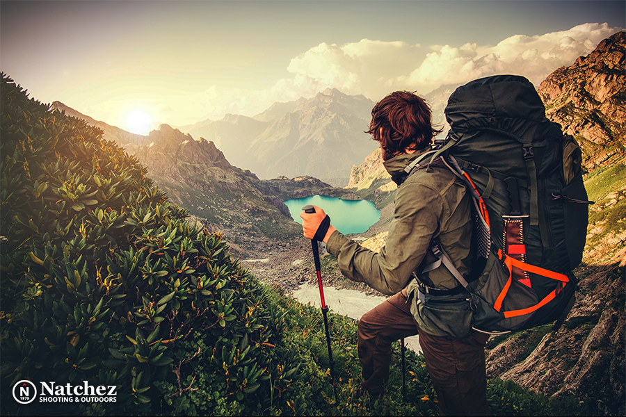 A backpacker at the top of a mountain looking at a lake in summer?