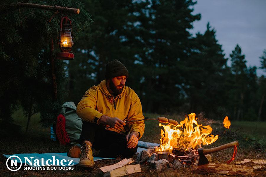 A backpacker preparing dinner by the fire?
