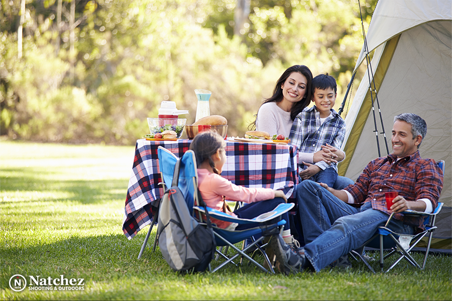 A camping family with two kids in front of a tent?