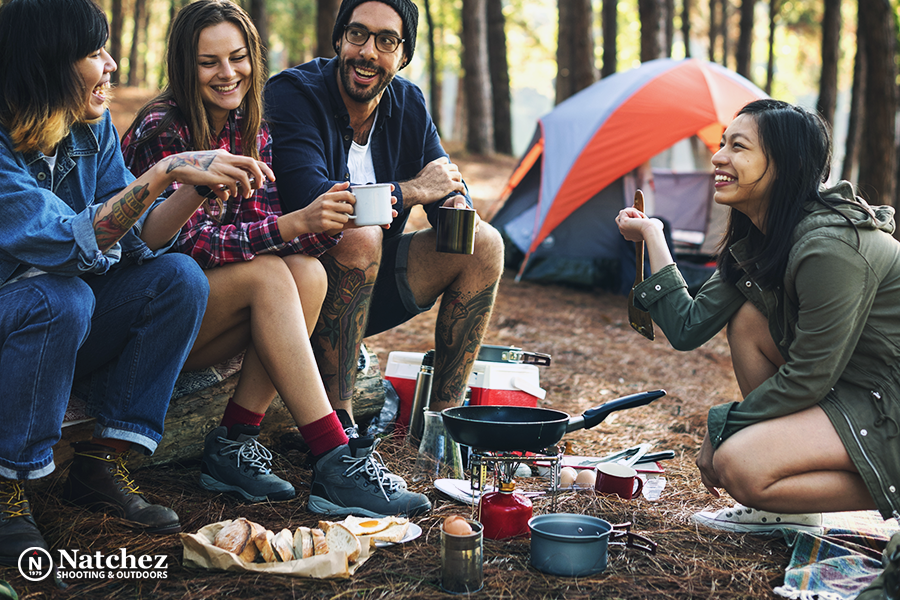 A group of friends preparing food on a campsite?