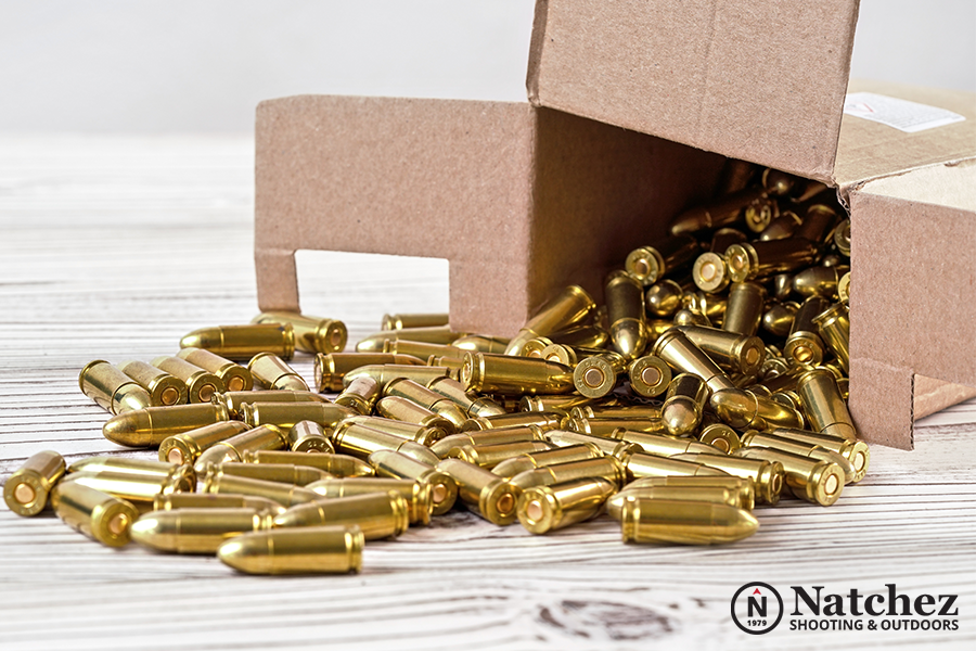 Brass ammunition next to a carton box